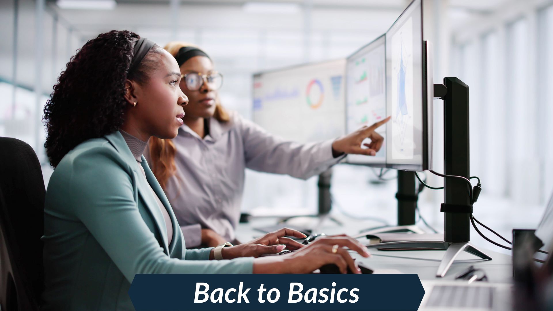 two people looking at a computer monitor